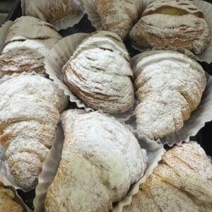 Powdered sugar pastries in paper liners