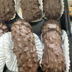 Chocolate-covered pastries in paper liners