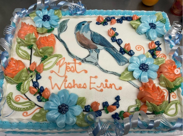 A cake with blue and orange flowers on it.