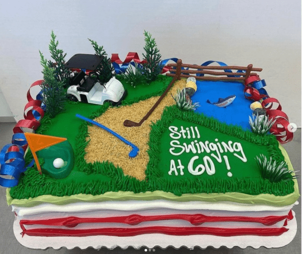 A cake with golf course and pond on it.