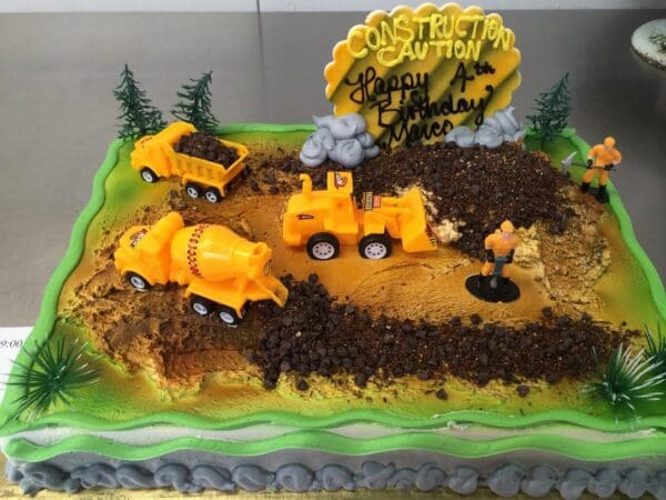 A cake with construction vehicles on it.