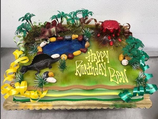 A birthday cake with an animal theme and the name of the birthday boy.