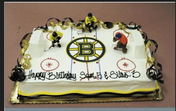 A birthday cake with hockey players on it.