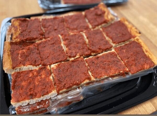 A tray of pizza sitting on top of a table.